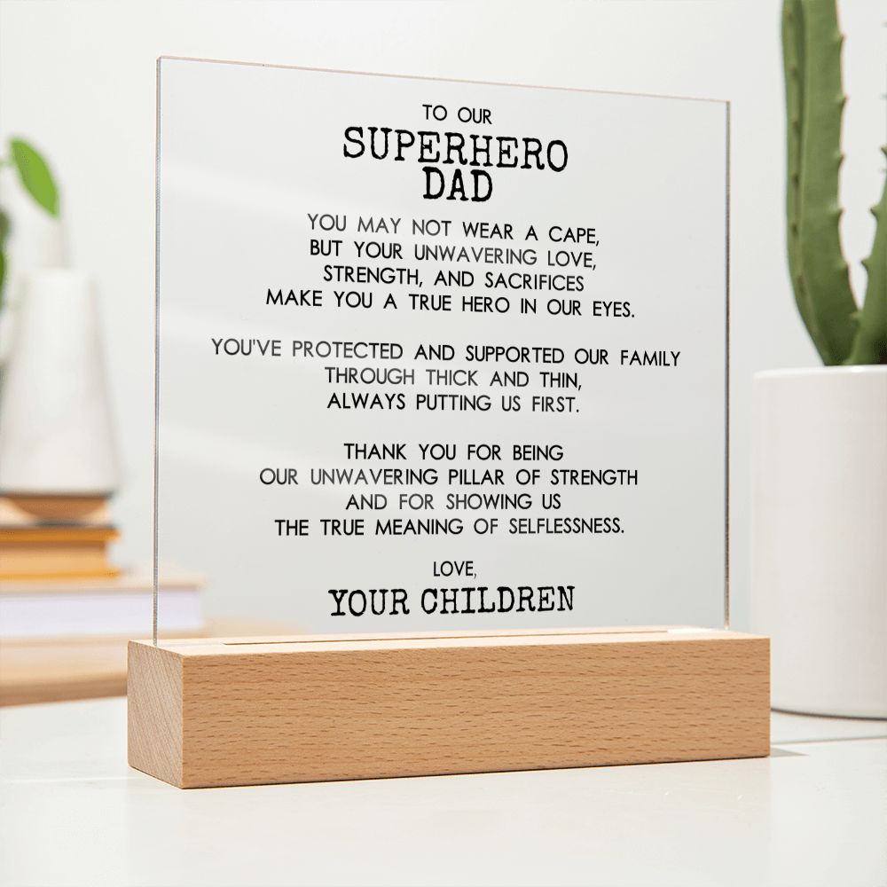 On The Desk Closer View Of Square Acrylic Plaque With Wooden Base With Message For Superhero Dad - Elegant Endearments